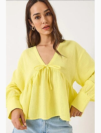 Blouse texturée courte à col en v et nœud lucci