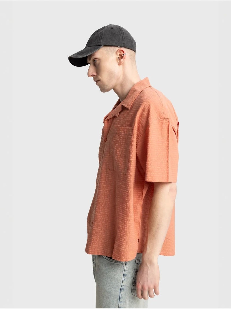 Chemise boutonnée en coton texturé avec poche giesto Orange clair - Kiabi