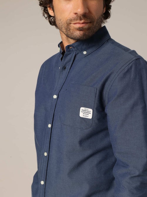 Chemise unie avec poche plaquée ornée d'un patch signature. 'Deeluxe' - Kiabi