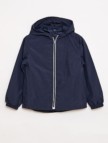 Coupe-vent uni qui se range dans sa capuche