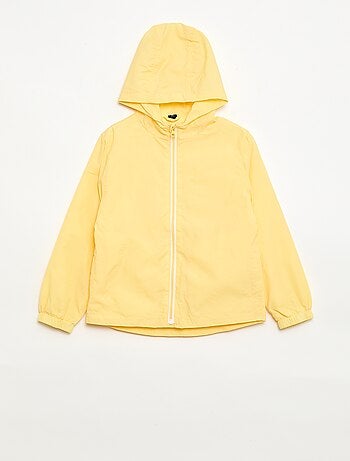 Coupe-vent uni qui se range dans sa capuche