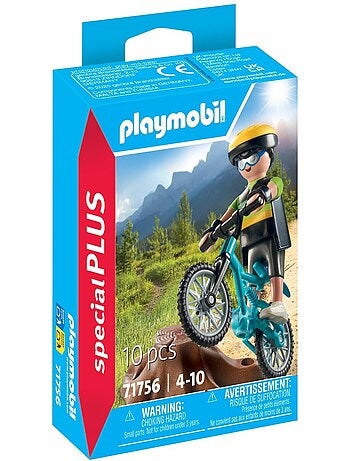 Cycliste avec vélo tout terrain et souche d'arbre