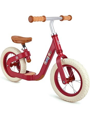 Draisienne rouge en métal avec repose pieds et assise en liège Hape