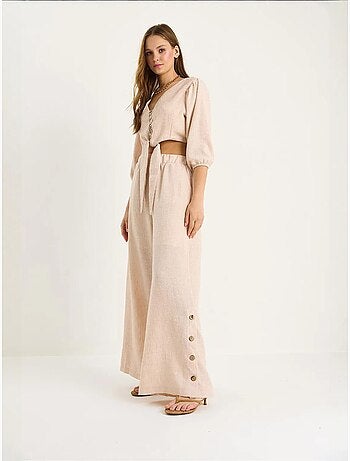 Ensemble deux pièces bianco avec chemisier à nouer, ourlet boutonné doublé et pantalon doublé lucci