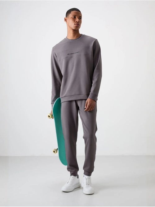 Ensemble sweat et pantalon en molleton imprimé tommy - Kiabi Ensemble sweat et pantalon en molleton imprimé tommy - Kiabi