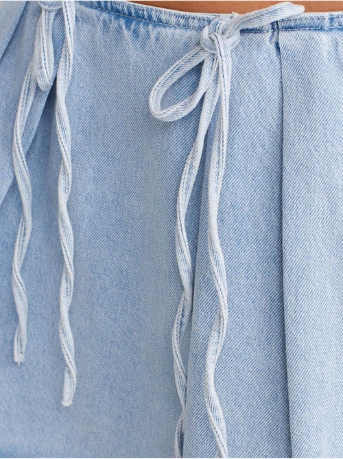 Jupe courte en denim de coton, coupe trapèze, nœud dilvin - Kiabi Jupe courte en denim de coton, coupe trapèze, nœud dilvin - Kiabi