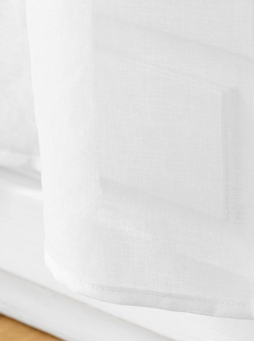 Paire de voilages passe-tringle en voile sablé avec finitions pompons - Kiabi