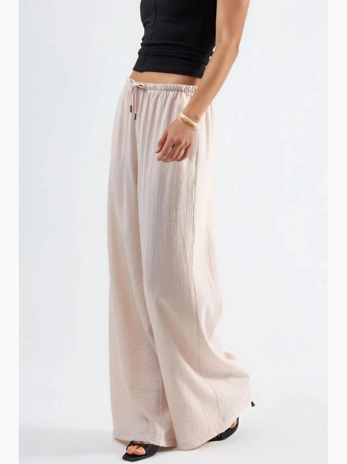 Pantalon à jambes larges et taille élastiquée avec cordon de serrage et poches busem - Kiabi Pantalon à jambes larges et taille élastiquée avec cordon de serrage et poches busem - Kiabi