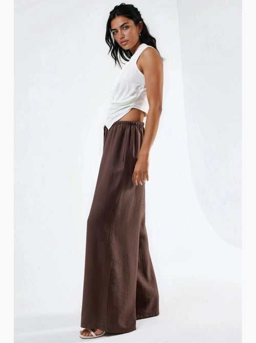 Pantalon à jambes larges et taille élastiquée avec cordon de serrage et poches busem - Kiabi Pantalon à jambes larges et taille élastiquée avec cordon de serrage et poches busem - Kiabi