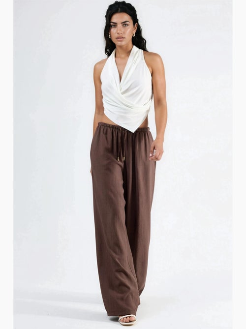 Pantalon à jambes larges et taille élastiquée avec cordon de serrage et poches busem - Kiabi Pantalon à jambes larges et taille élastiquée avec cordon de serrage et poches busem - Kiabi
