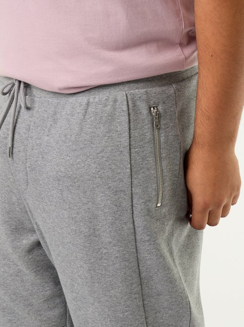 Pantalon de jogging avec bas resserré et poches zippées - Kiabi