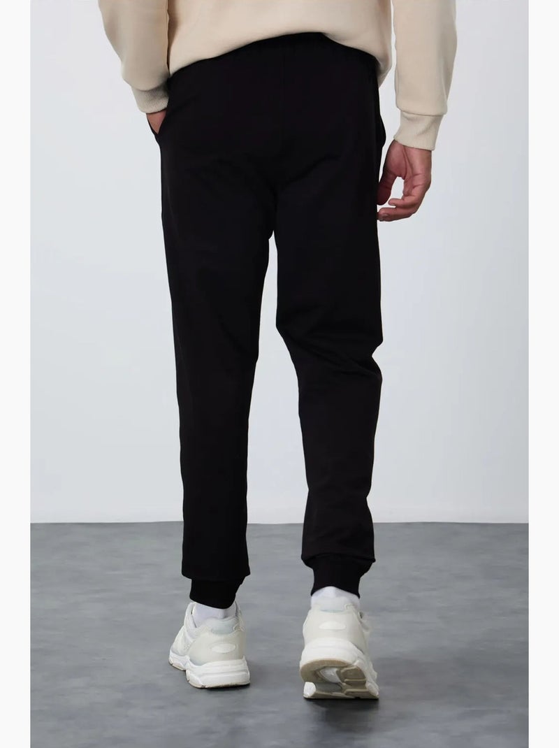 Pantalon de jogging homme en molton uni tommy Noir - Kiabi