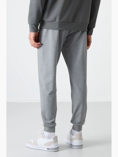 Pantalon de jogging homme uni avec poche zippée tommy - Kiabi Pantalon de jogging homme uni avec poche zippée tommy - Kiabi