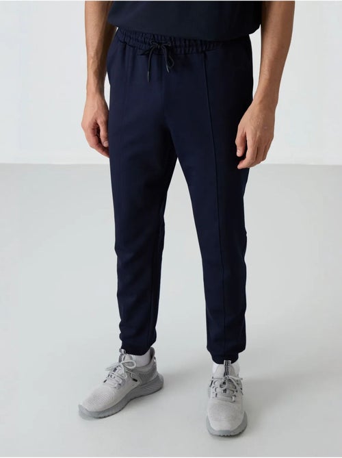 Pantalon de survêtement homme jogger en molleton tommy - Kiabi Pantalon de survêtement homme jogger en molleton tommy - Kiabi