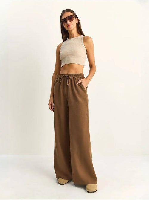 Pantalon en coton à jambes larges avec cordon à la taille lucci - Kiabi Pantalon en coton à jambes larges avec cordon à la taille lucci - Kiabi