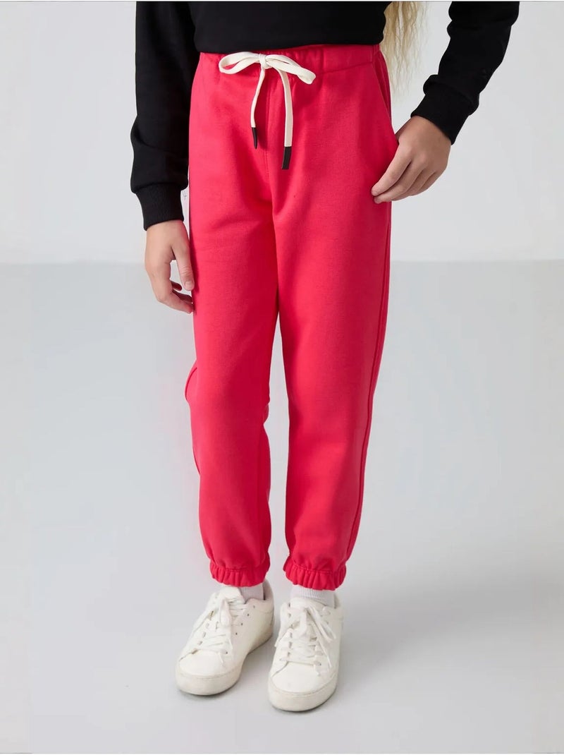 Pantalon jeune à taille cordon tommy Rose fluo/Solinotes - Kiabi