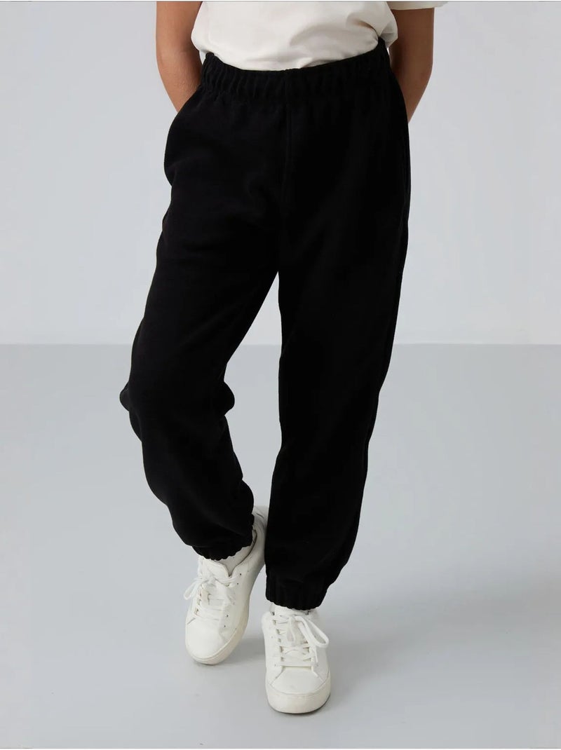 Pantalon jeunesse uni tommy Noir - Kiabi