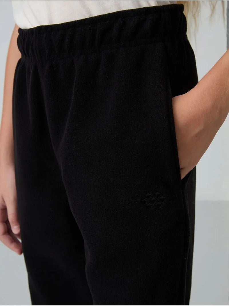 Pantalon jeunesse uni tommy Noir - Kiabi