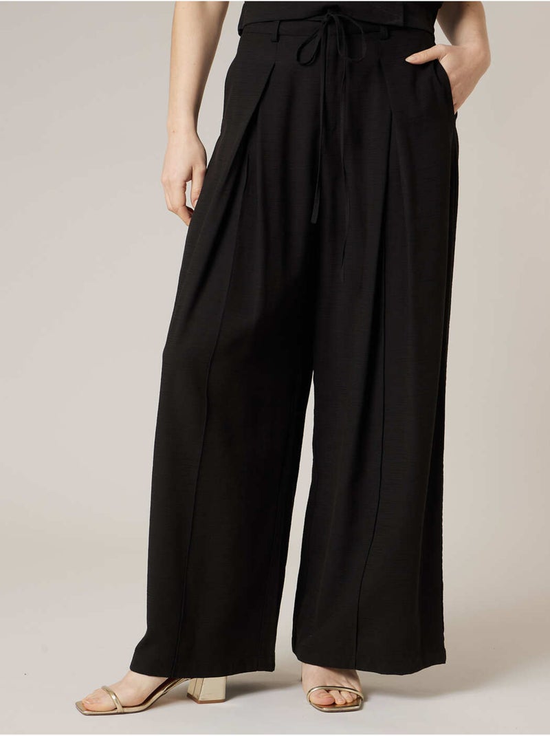 Pantalon large femme en matière fluide 'Deeluxe' Noir - Kiabi
