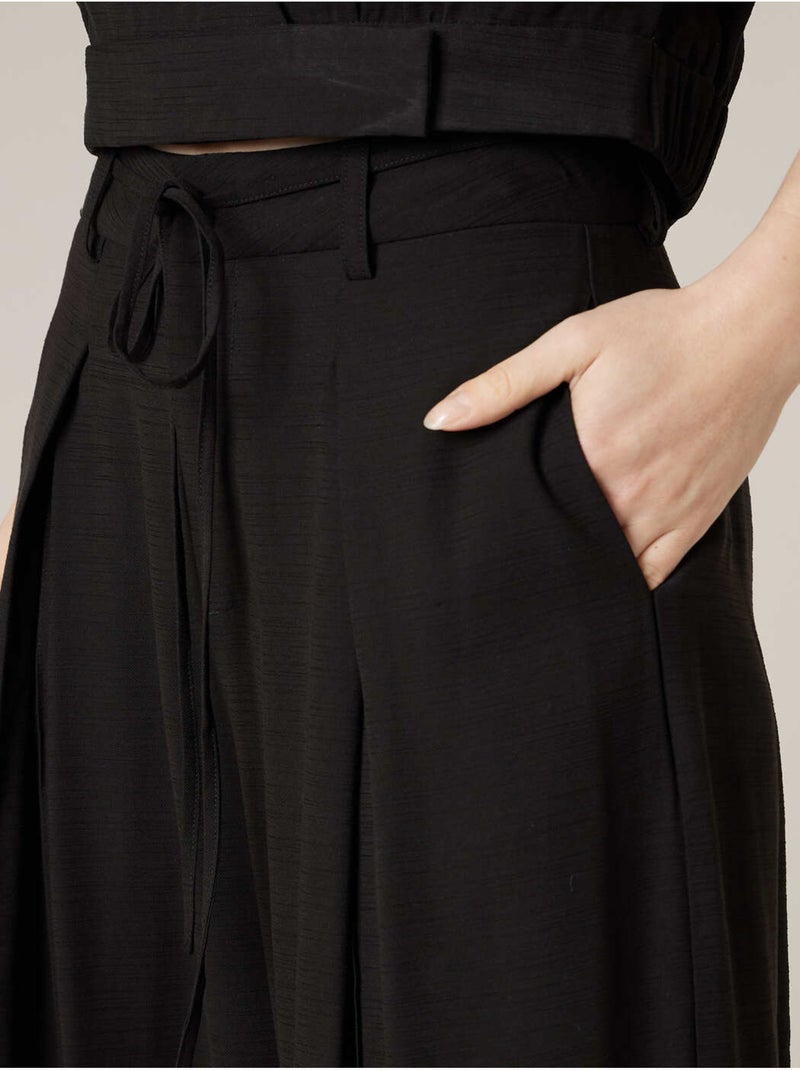 Pantalon large femme en matière fluide 'Deeluxe' Noir - Kiabi