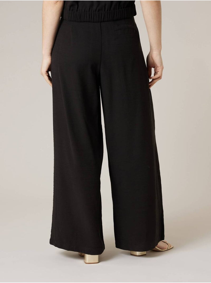 Pantalon large femme en matière fluide 'Deeluxe' Noir - Kiabi
