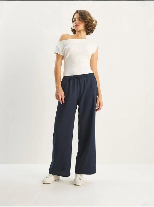 Pantalon palazzo à jambes larges et fermeture à nouer lucci - Kiabi Pantalon palazzo à jambes larges et fermeture à nouer lucci - Kiabi