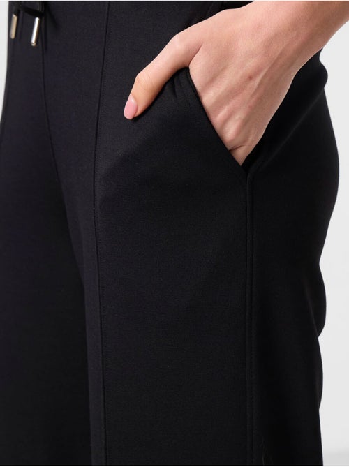 Pantalon palazzo texturé à jambes larges avec cordon de serrage à la taille tommy - Kiabi Pantalon palazzo texturé à jambes larges avec cordon de serrage à la taille tommy - Kiabi