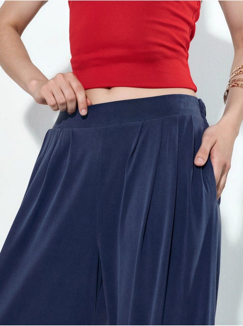 Pantalon plissé taille haute à jambes larges busem - Kiabi Pantalon plissé taille haute à jambes larges busem - Kiabi