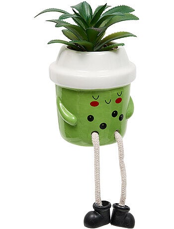 Plante artificielle en pot en céramique avec visage
