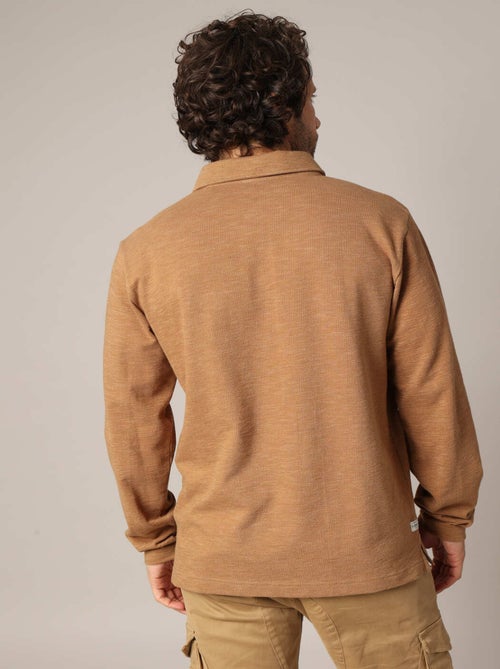 Polo à manches longues avec poche poitrine et patte de boutonnage contrastée
 'Deeluxe' - Kiabi