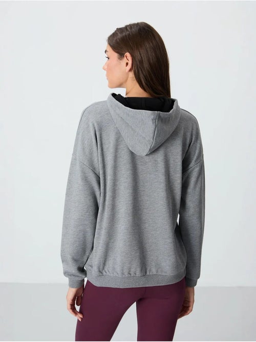 Sweat à capuche oversize avec poche tommy - Kiabi Sweat à capuche oversize avec poche tommy - Kiabi