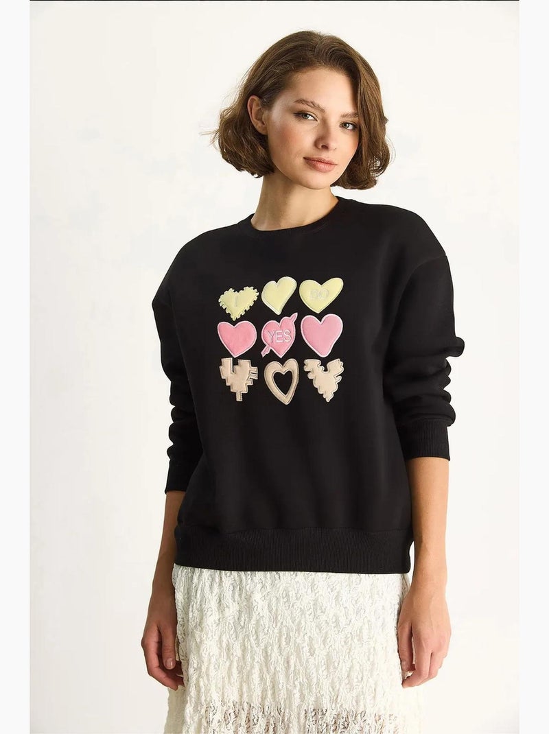 Sweat-shirt à col rond et coupe décontractée avec écusson cœur lucci Noir - Kiabi