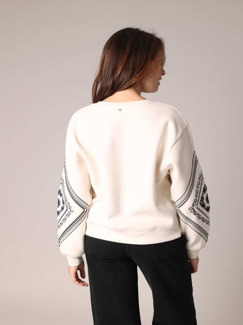Sweat-shirt en polaire douce à manches longues ballon décorées de motifs brodés
 'Deeluxe' - Kiabi
