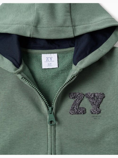 Sweat zippé en coton avec capuche et broderie en bouclettes zy - Kiabi Sweat zippé en coton avec capuche et broderie en bouclettes zy - Kiabi