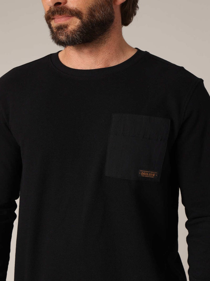 T-shirt à manches longues 100% coton avec poche poitrine contrastée.
 'Deeluxe' Noir - Kiabi