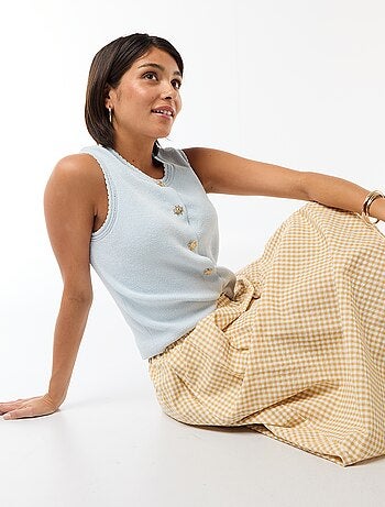 Top sans manches avec boutons dorés